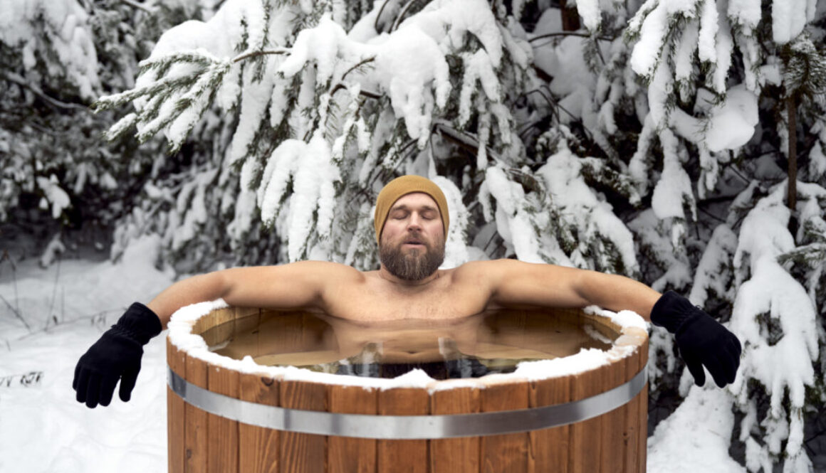 Caucasian man take the winter bath in tube outdoors in forest