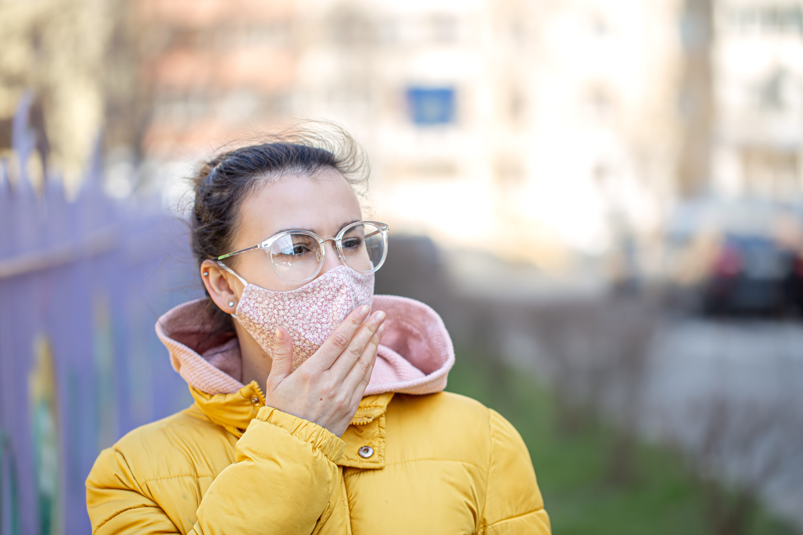 A young woman in a mask during the pandemic Coronavirus.
