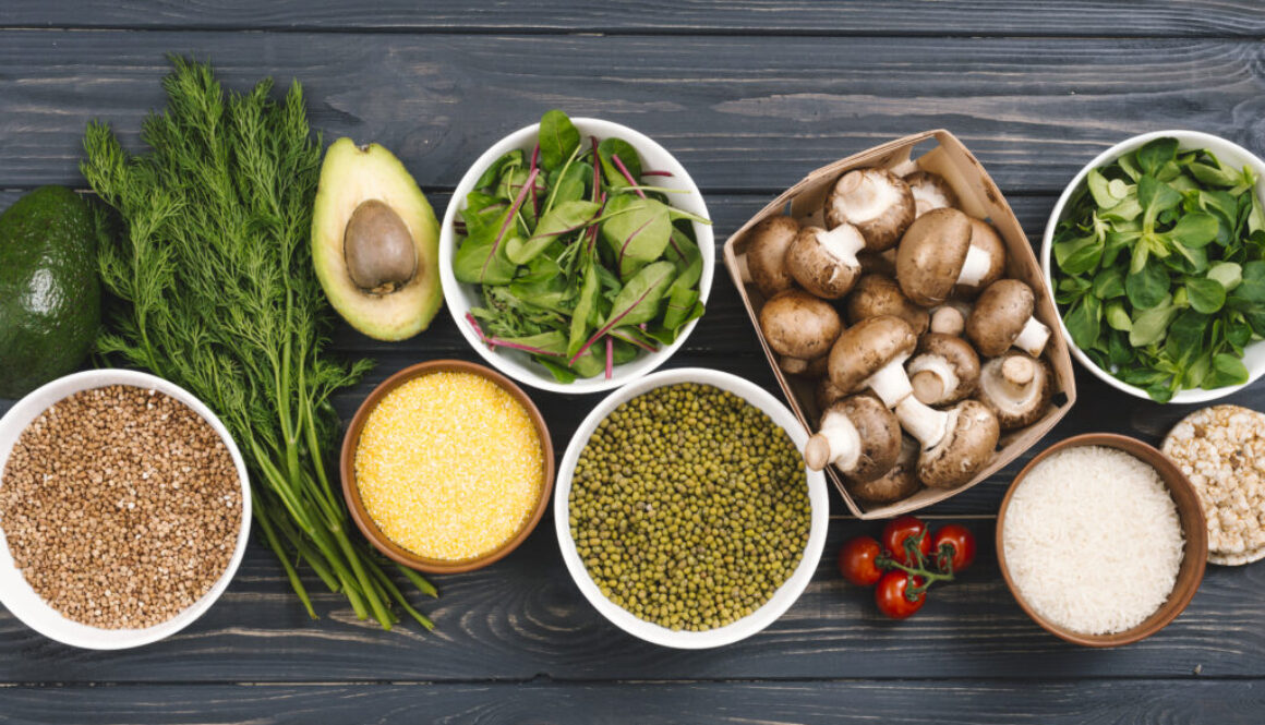 elevated-view-fresh-vegetables-pulses-black-wooden-desk