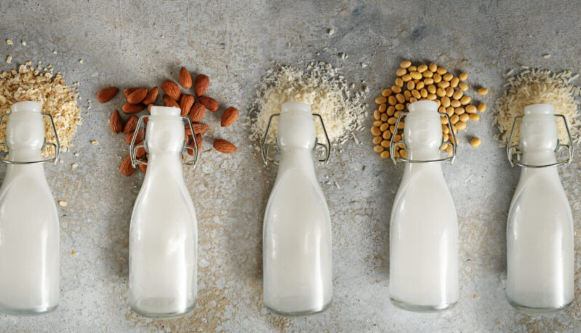 Bottles with different vegan milk and the ingredients like soy, rastlinné mlieko