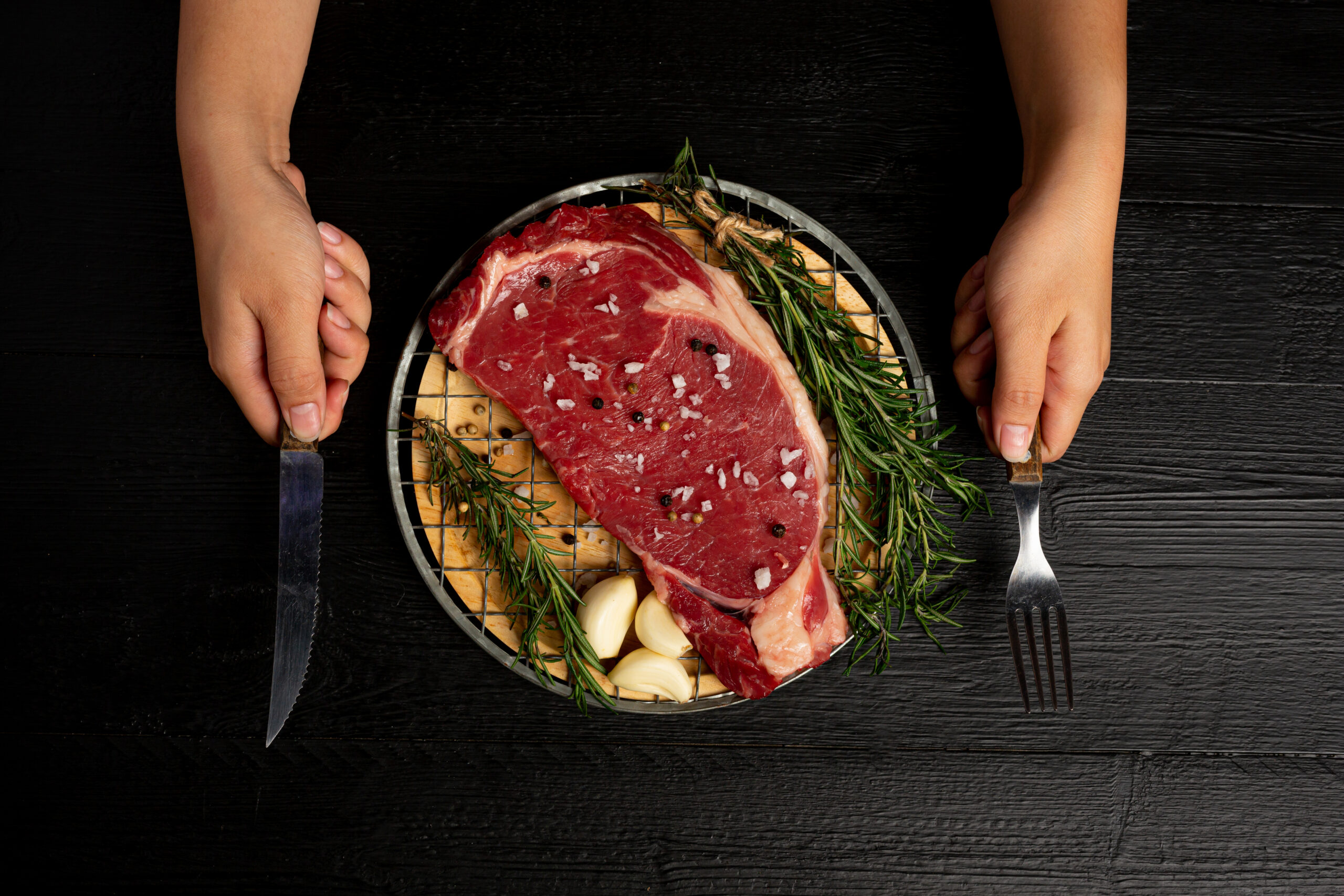 fresh raw beef steak on the dark background.