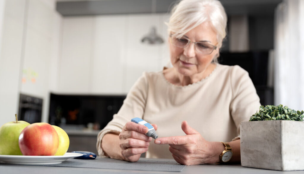 Senior woman checking her blood glucose level