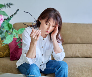 Middle-aged woman experiencing stress, difficulties, headache