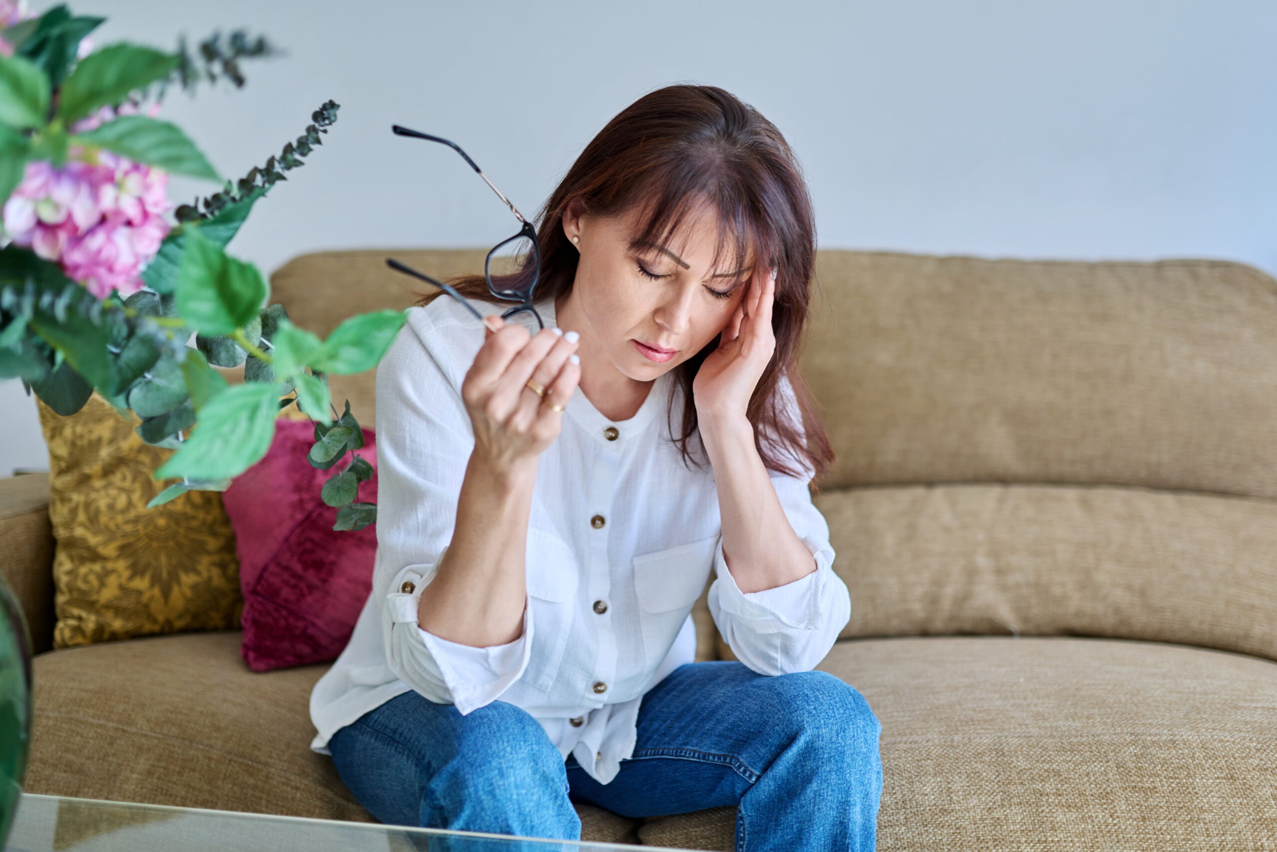 Middle-aged woman experiencing stress, difficulties, headache